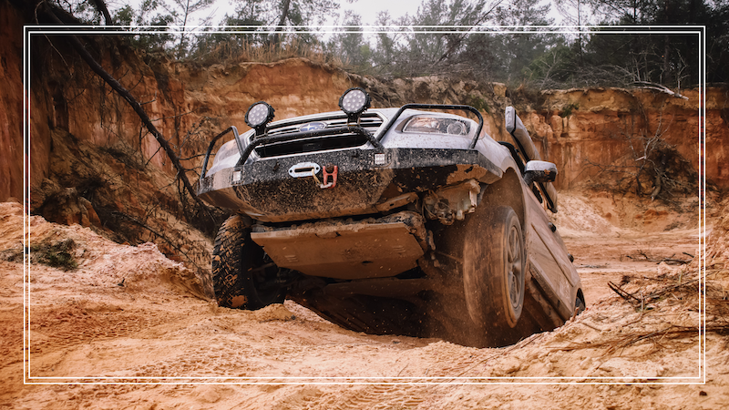 A vehicle off roading in the mud 